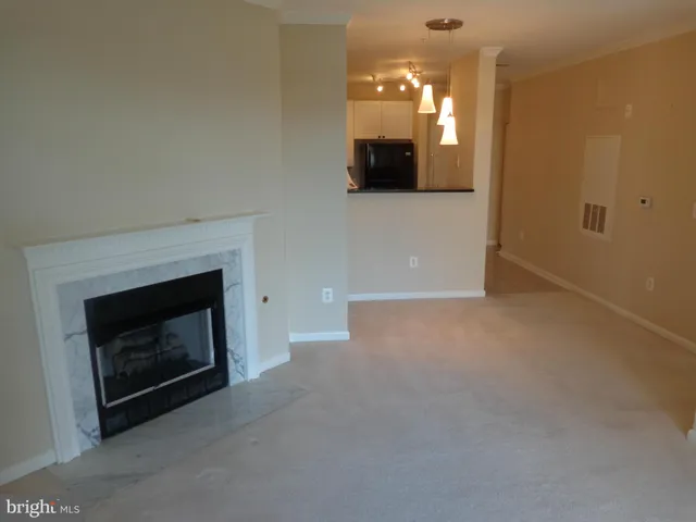 a view of empty room with a fireplace