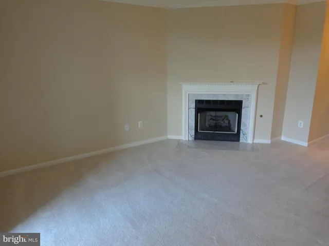 a view of empty room with a fireplace