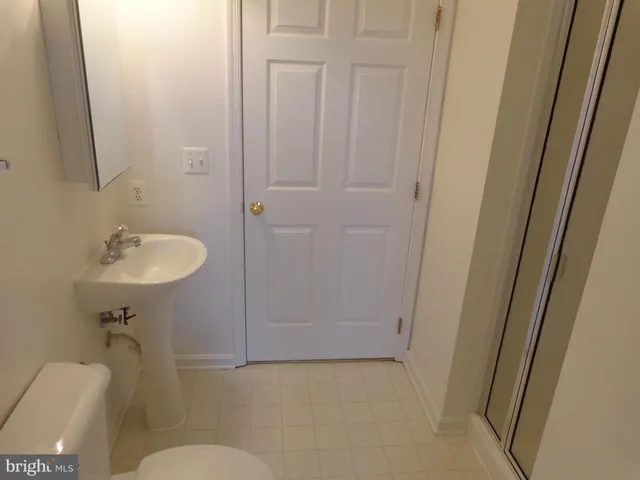 a bathroom with a sink toilet and mirror