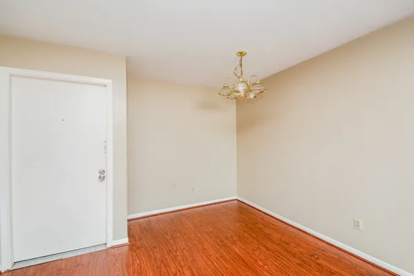 a view of a room with wooden floor