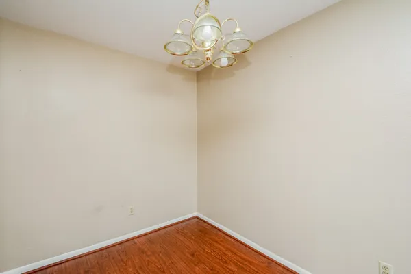 a view of a hallway with a chandelier fan