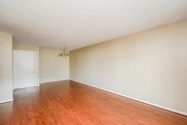 a view of an empty room and wooden floor