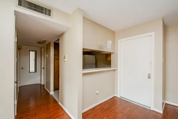 a view of hallway with wooden floor