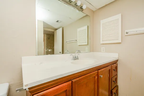 a room with a sink and a mirror