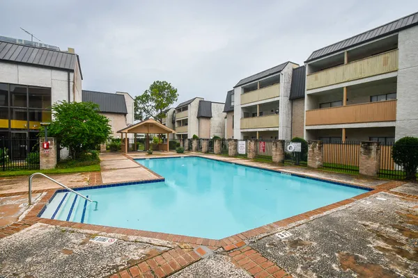 a view of an house with swimming pool and porch