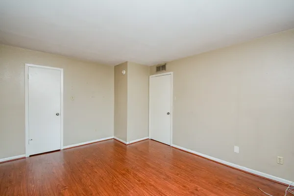a view of an empty room and wooden floor