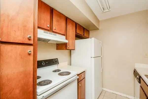a kitchen with a refrigerator and a stove