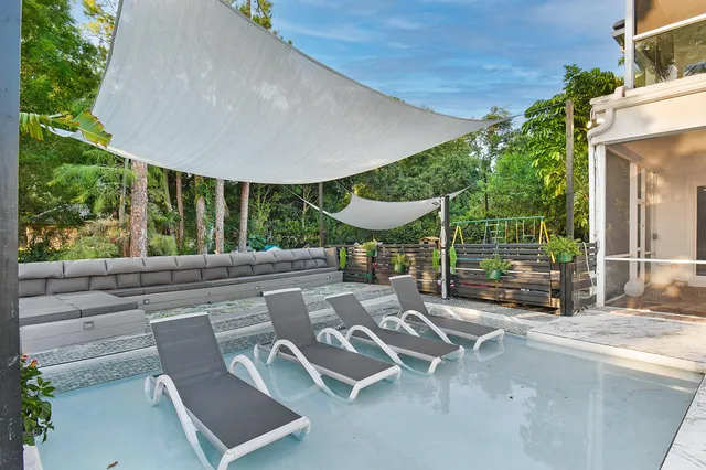 a view of a backyard with sitting area