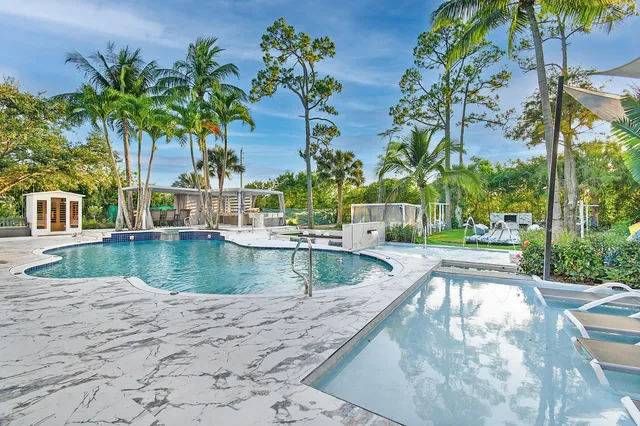 a room with gym equipment and potted plants