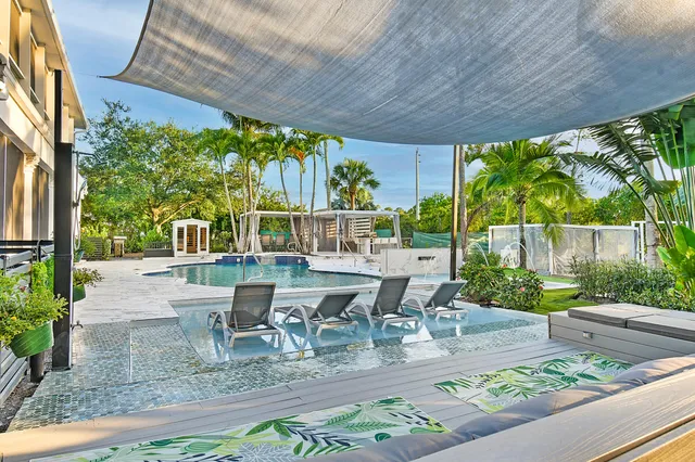 swimming pool view with a seating space