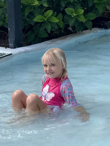 a view of backyard with seating area and trees