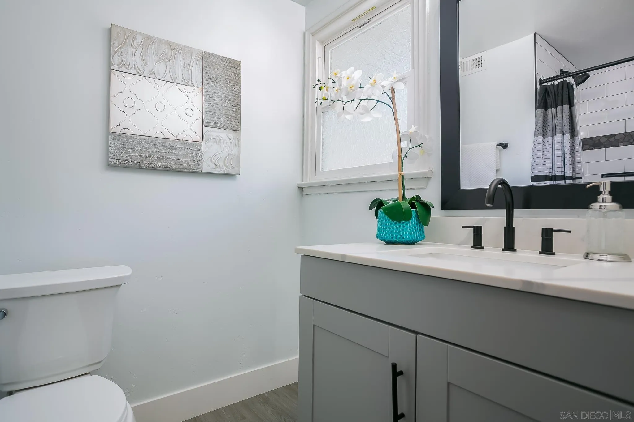 12221 Witt Road Poway, CA 92064 - Photo 11 of 30 a bathroom with a sink a toilet and mirror