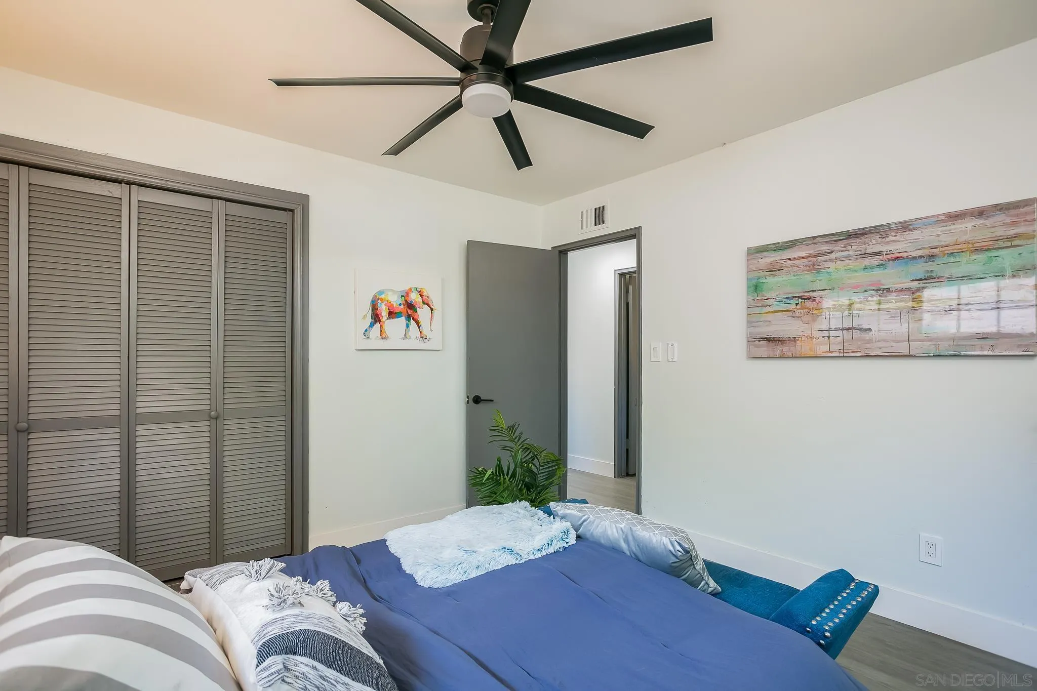 12221 Witt Road Poway, CA 92064 - Photo 16 of 30 a bedroom with a bed and a chandelier