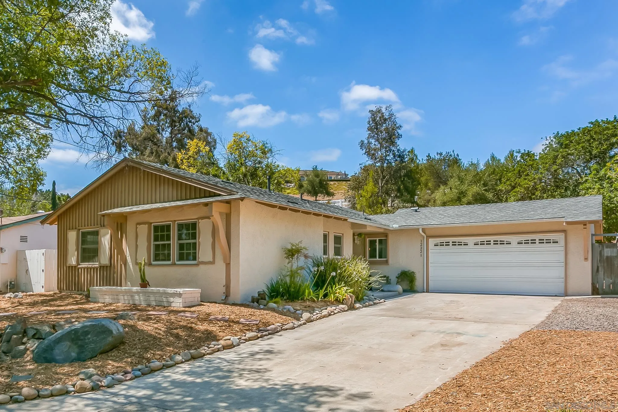 12221 Witt Road Poway, CA 92064 - Photo 2 of 30 a front view of a house with a yard and garage