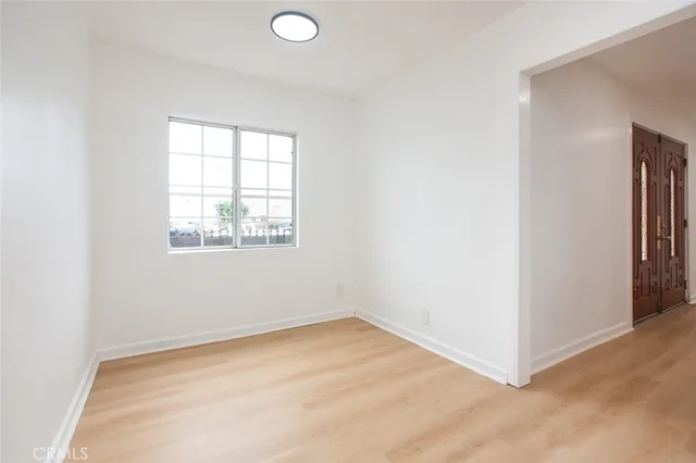 a kitchen with cabinets stainless steel appliances and a wooden floor