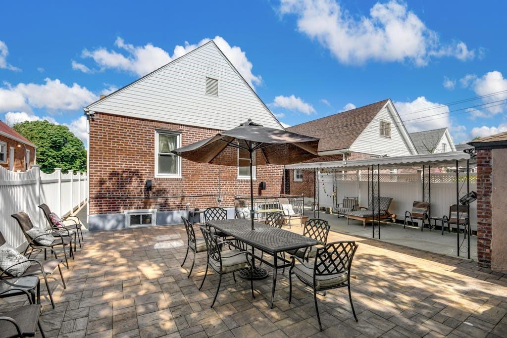 130-13 230th Street Queens, NY 11413 - Photo 12 of 12 a patio with table and chairs