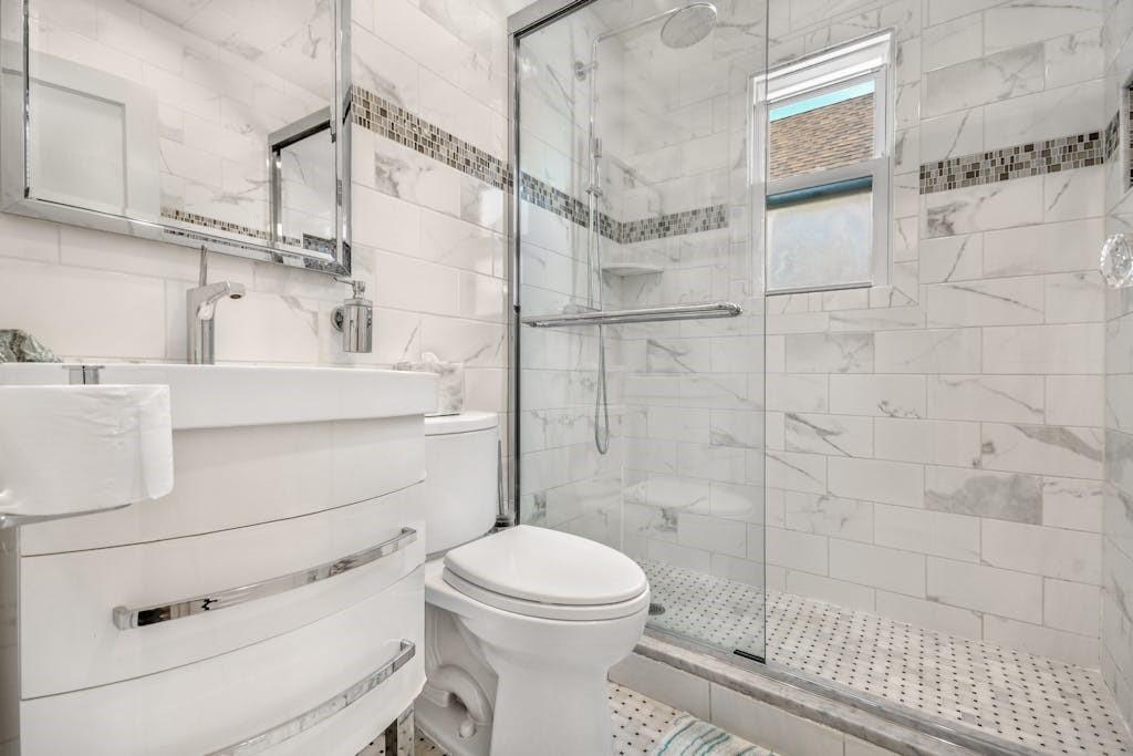 130-13 230th Street Queens, NY 11413 - Photo 3 of 12 a bathroom with a toilet sink and shower