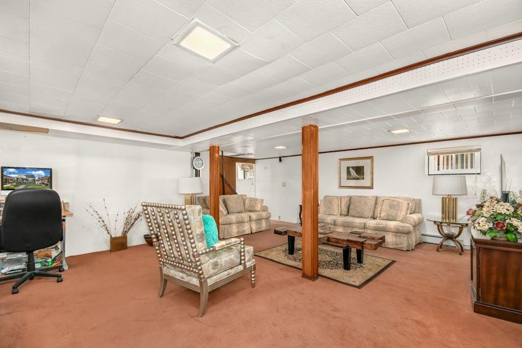 130-13 230th Street Queens, NY 11413 - Photo 4 of 12 a living room with furniture and a large window
