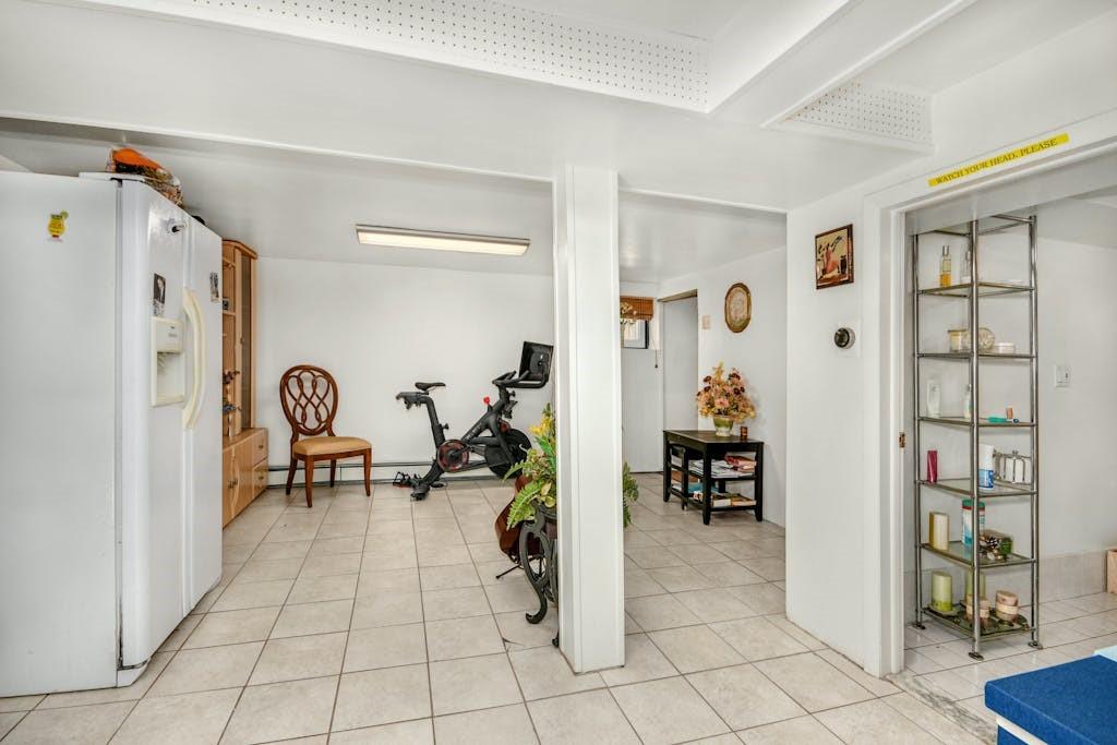 130-13 230th Street Queens, NY 11413 - Photo 6 of 12 a view of a livingroom with furniture and gym equipment