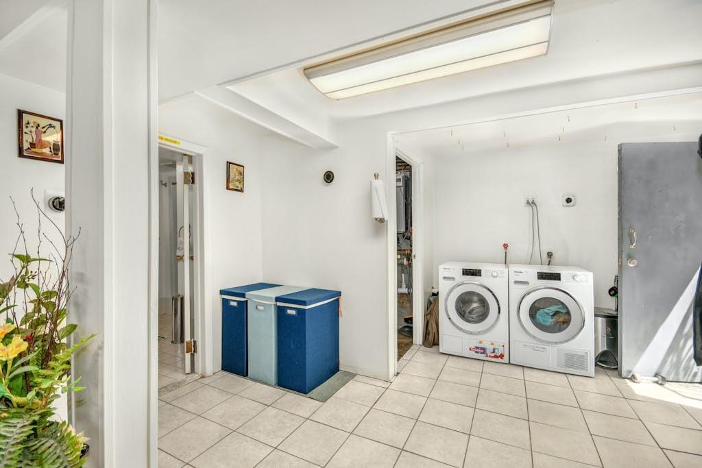 130-13 230th Street Queens, NY 11413 - Photo 7 of 12 a view of a storage and utility room with washer and dryer