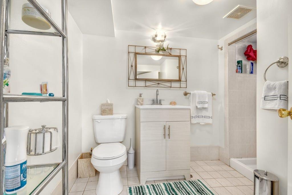 130-13 230th Street Queens, NY 11413 - Photo 8 of 12 a bathroom with a sink a toilet and shower