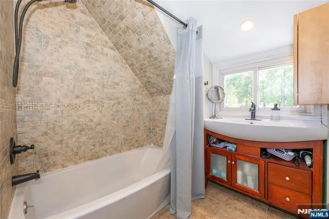 a bathroom with a sink double vanity and a bathtub