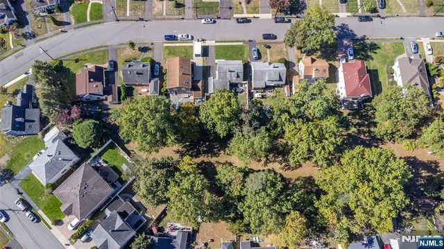 an aerial view of multiple houses with yard