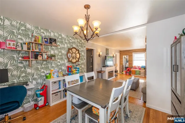 a view of a dining room with furniture and a chandelier