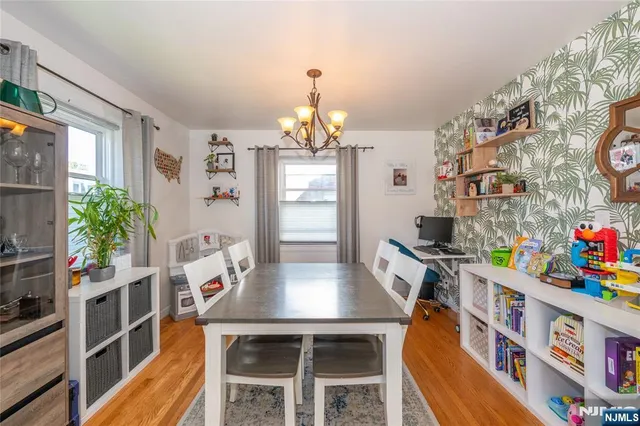 a view of a dining room with furniture and a potted plant