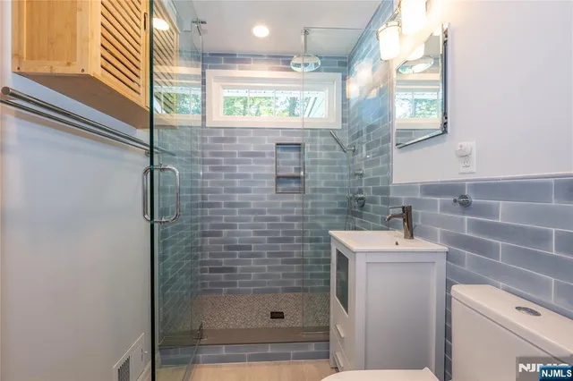 a bathroom with a shower a toilet and sink