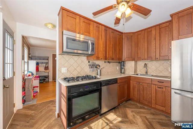a kitchen with stainless steel appliances granite countertop a stove sink and cabinets