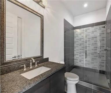 223 16th Street Northwest, Unit 8 Atlanta, GA 30363 - Photo 39 of 43 a bathroom with a granite countertop sink toilet and shower
