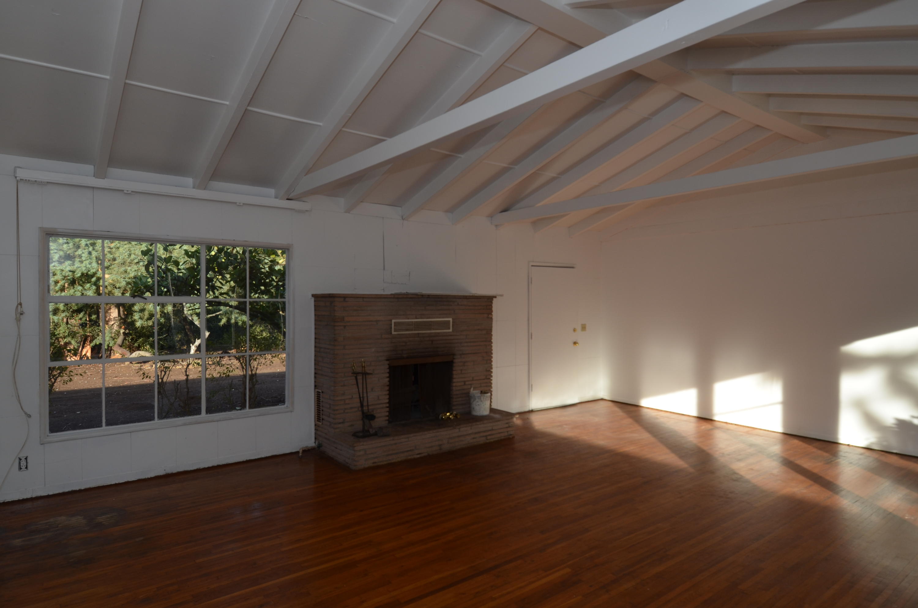 1409 School House Road Montecito, CA 93108 - Photo 2 of 5 a view of empty room with wooden floor and fireplace