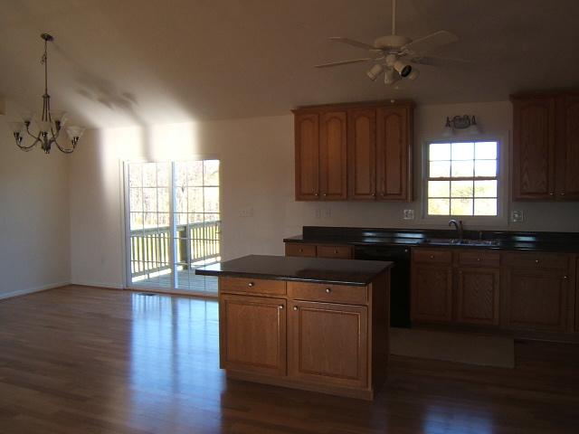 1792 Emmaus Church Road Moneta, VA 24121 - Photo 8 of 14 a kitchen with granite countertop a stove a sink and wooden floors