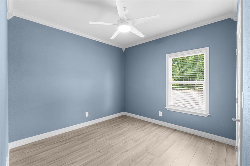 1011 Southeast County Road Corsicana, TX 75109 - Photo 24 of 40 wooden floor in an empty room with a window