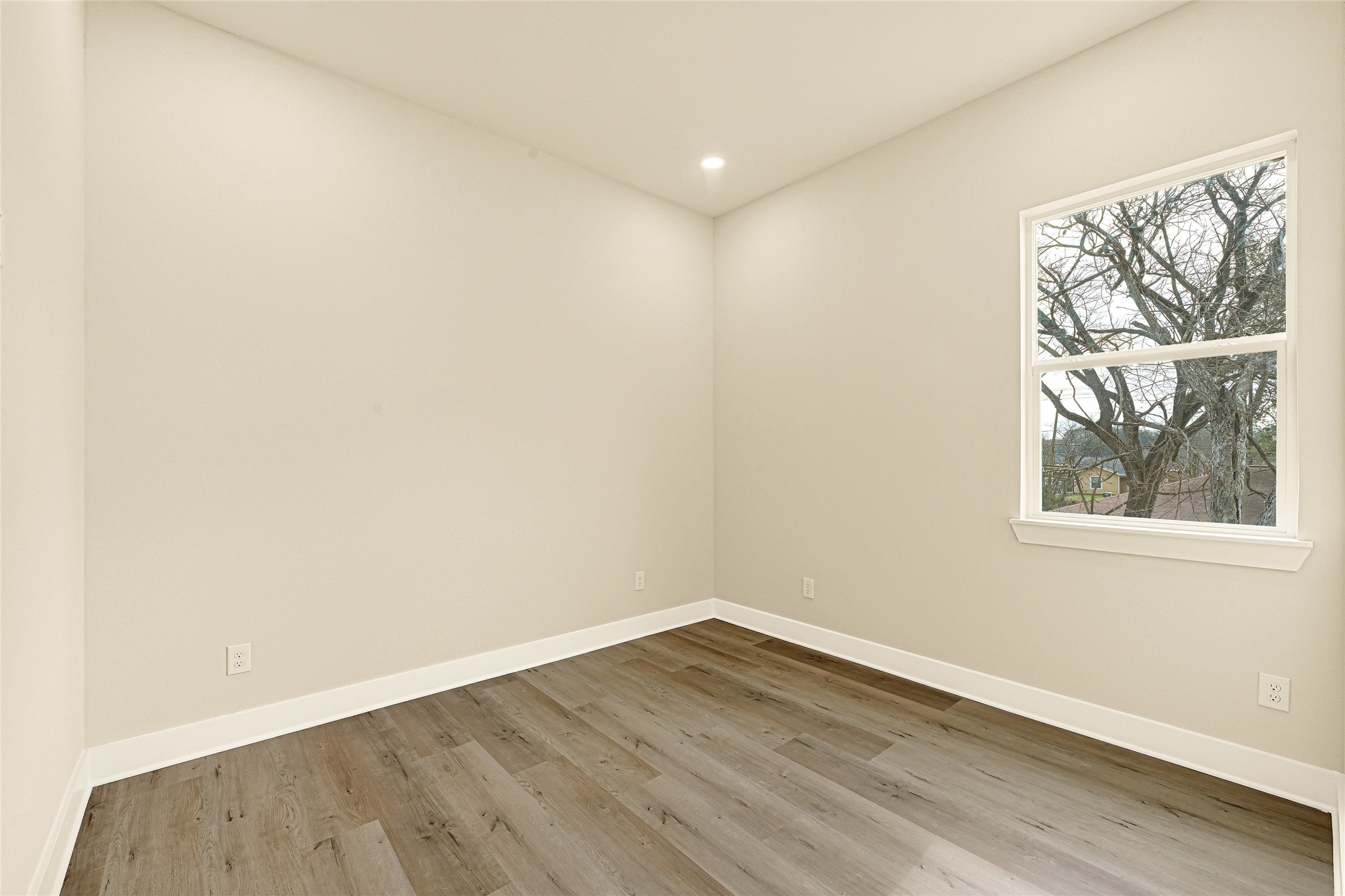 702 Savonna Houston, TX 77076 - Photo 16 of 28 an empty room with wooden floor and a window