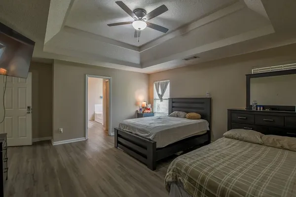 a bedroom with two beds and a flat screen tv