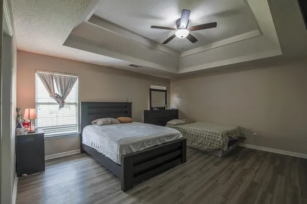 a bedroom with a bed and a chandelier