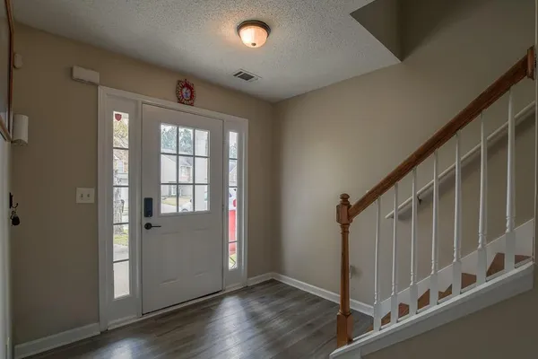 a view of an entryway with wooden floor