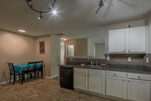 a kitchen with sink and cabinets