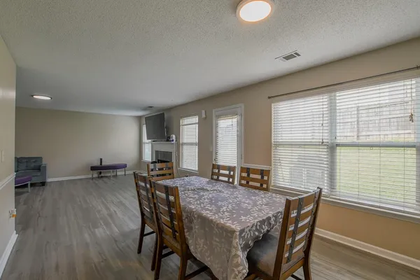 a dining room with furniture and wooden floor