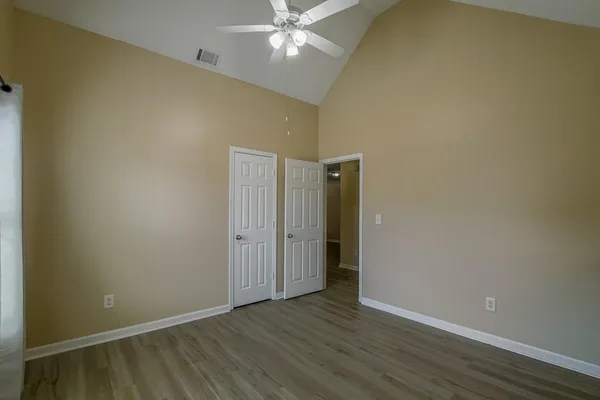 a view of an empty room with wooden floor
