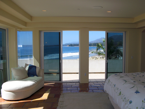875 Sand Point Road Carpinteria, CA 93013 - Photo 4 of 12 a bedroom with a bed and glass door