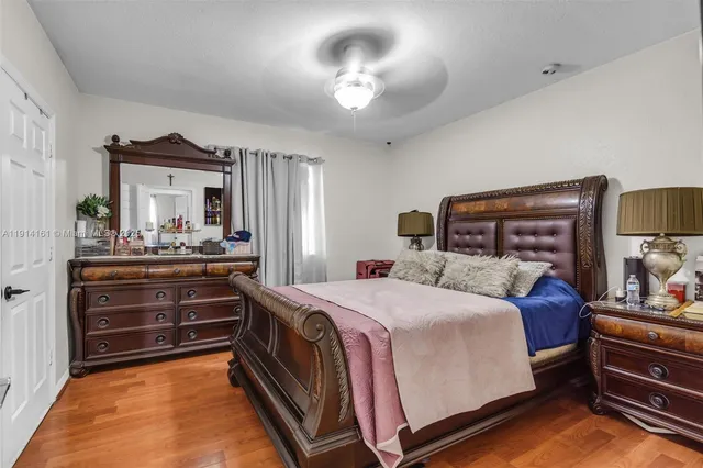 a bedroom with a bed and ceiling fan