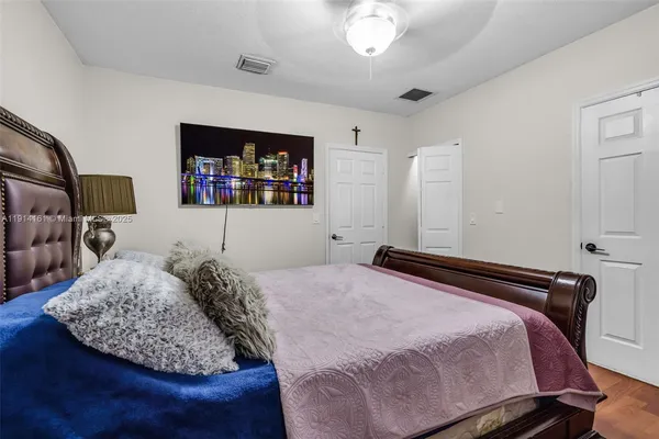 a bedroom with a bed window and dresser