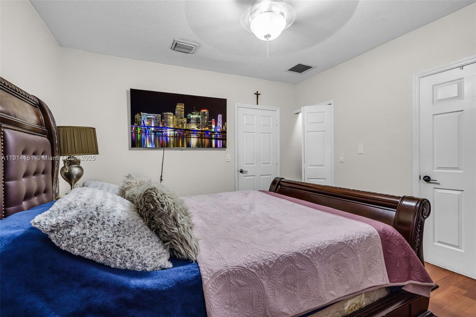 7271 Northwest 174th Terrace, Unit 202 Hialeah, FL 33015 - Photo 13 of 22 a bedroom with a bed window and dresser