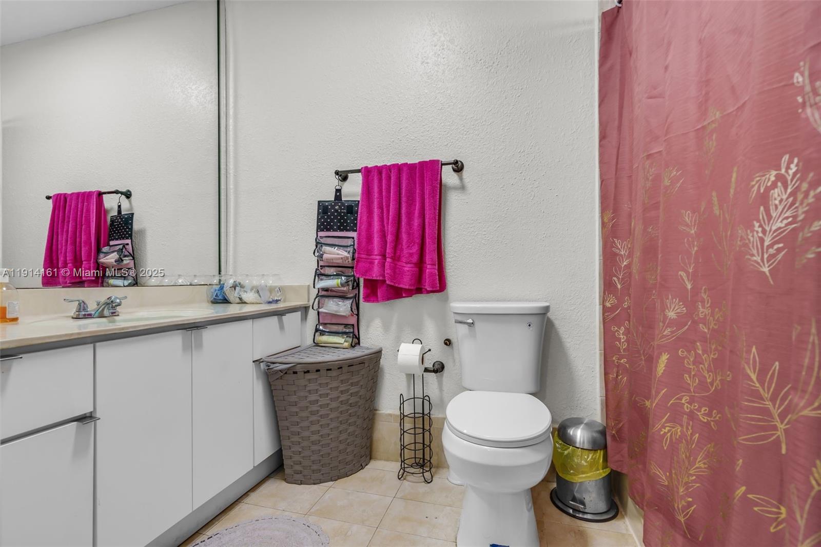 7271 Northwest 174th Terrace, Unit 202 Hialeah, FL 33015 - Photo 15 of 22 a bathroom with a toilet sink vanity and mirror