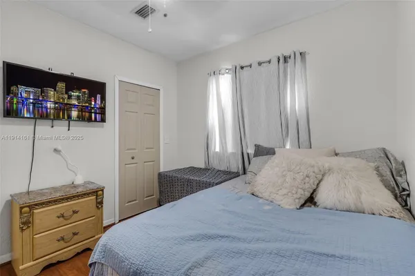 a bedroom with a bed and a television