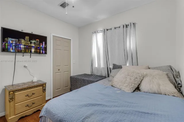 a bedroom with a bed and a television
