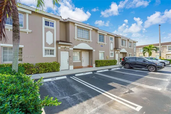 a front view of a house with a yard and outdoor seating